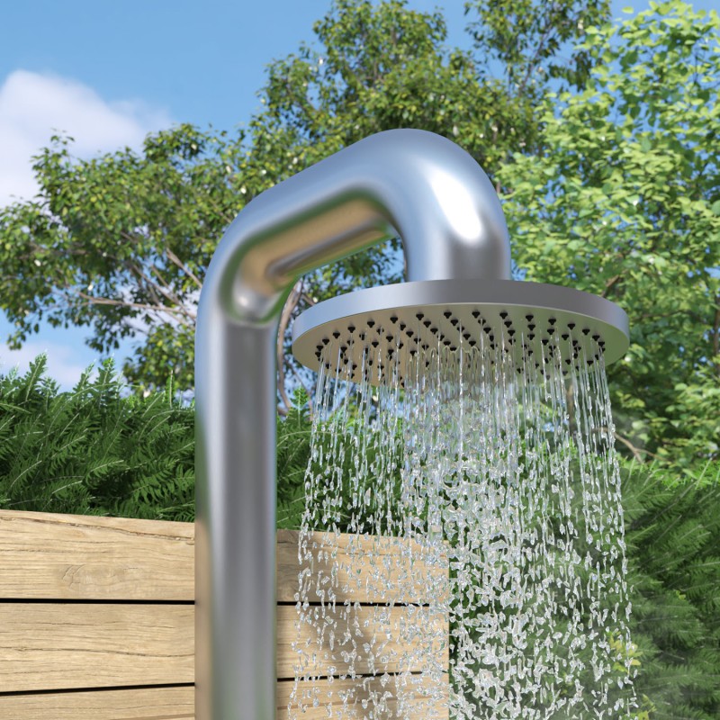 Proud vody ze sprchové hlavice venkovní sprchy fatline 04 umístěné u dřevěné stěny v zahradě